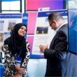 Attendees at Reach Higher Showcase discuss a project